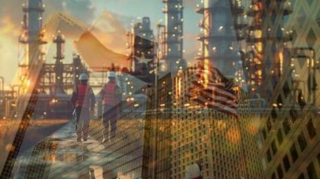 Workers walking near the industrial skyline with the USA and Texas Flag in background.